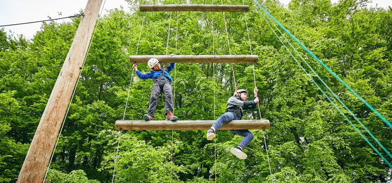 school pupils on a high ropes course at an activity adventure centre