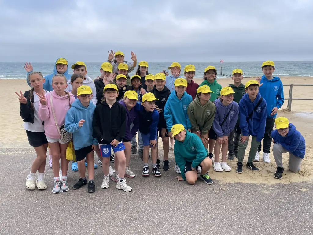 The School Journey Association School Trips 1 school group at the seaside having a photo taken of their school trip