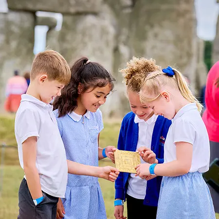 Examining a replica of the Bronze Age Bush Barrow lozenge, a gold plaque found in a burial mound in the Stonehenge landscape
