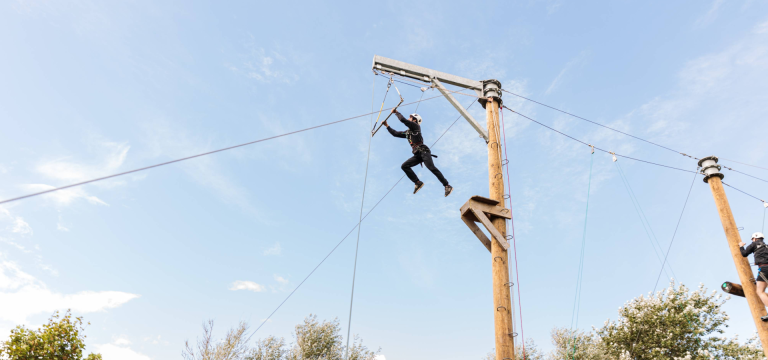school pupil on high ropes course and zip wire