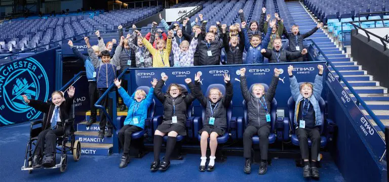 school group sitting in part of a football stadium