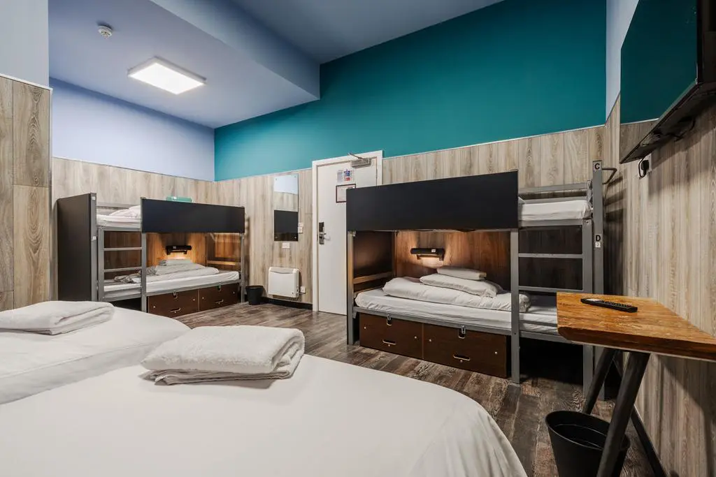 indoor bunkhouse room with beds desk and chairs