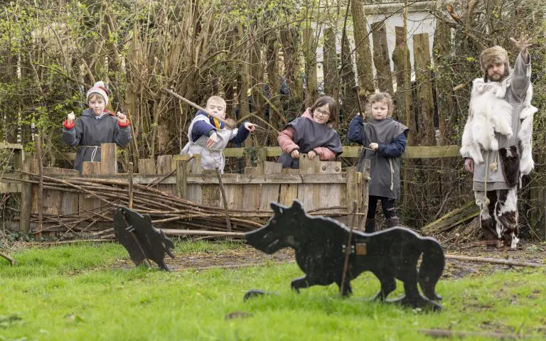 school children doing archery