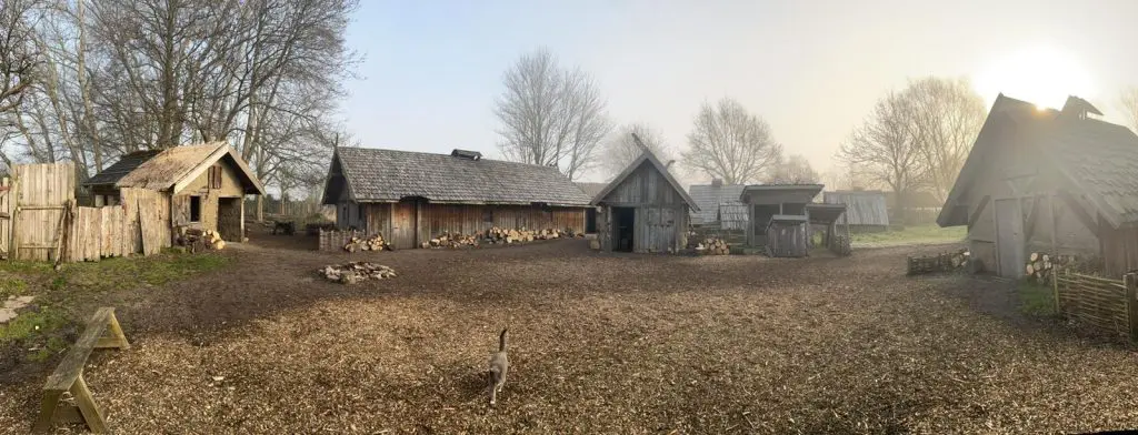 Celtic farm village with wooden huts and farm animals