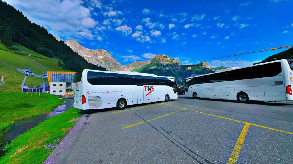 two single decker coaches in car park