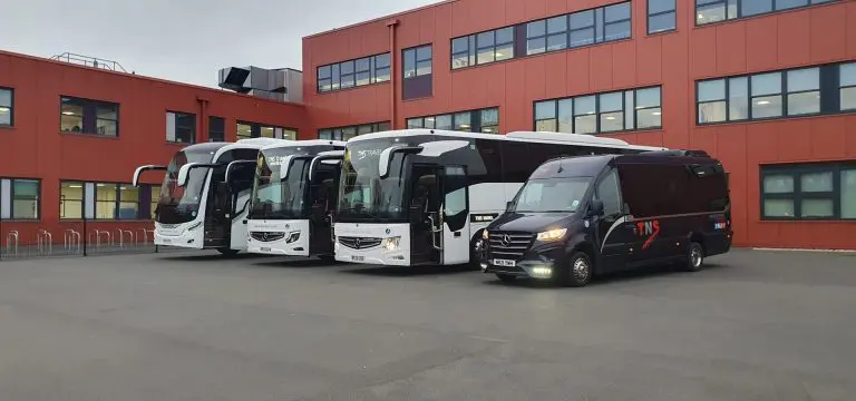 coaches at HQ office block parked outside