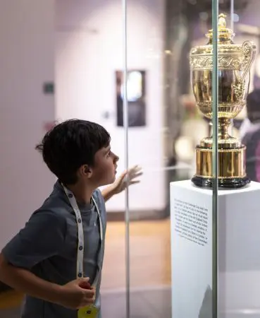 school pupil looking at a trophy cabinet