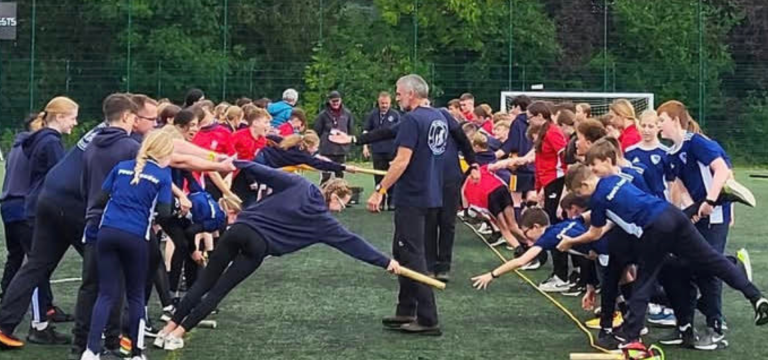 students doing team activities outside on a five a side pitch