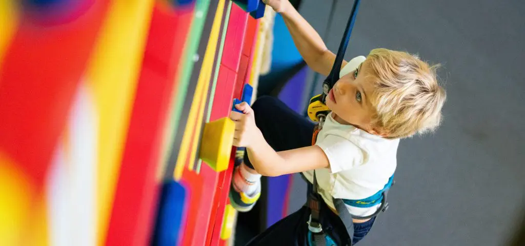 pupil on a climbing hang wall