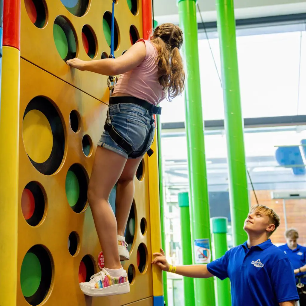 pupil climbing up an indoor climbing wall