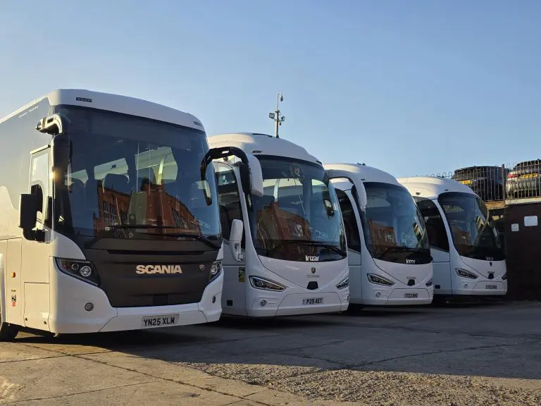 four coaches parked in car park