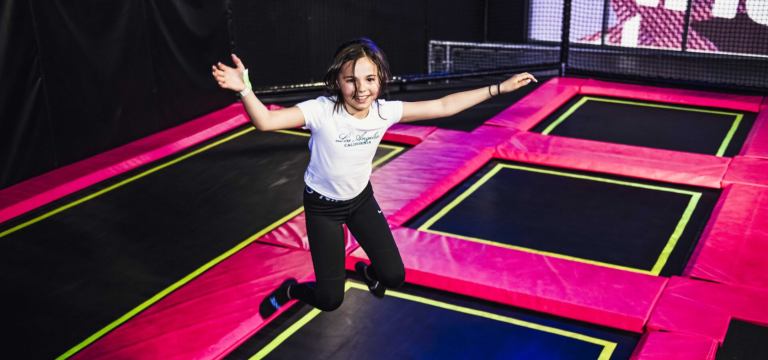 school pupil jumping up and down on a trampoline