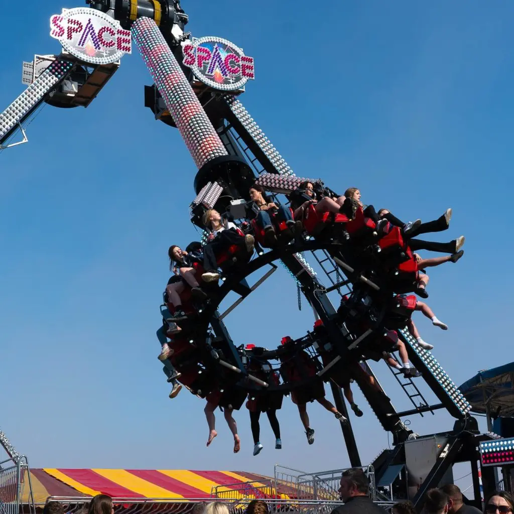 students at a theme park ride called space