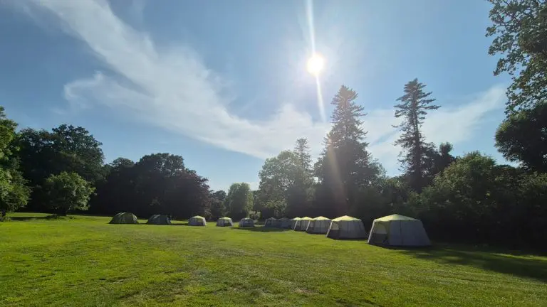 field in the countryside with 12 bell tents