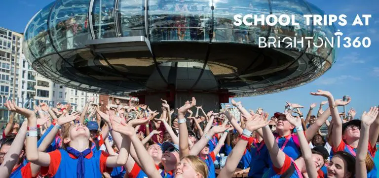 image showing school group with hands in the air and in the background the image of the i360