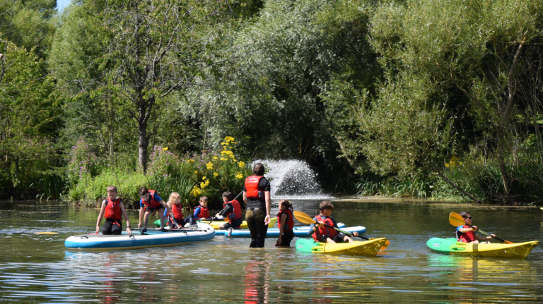 image of primary pupils kayaking in lake at Adventure 4 You Outdoor Activity Centre Northamptonshire