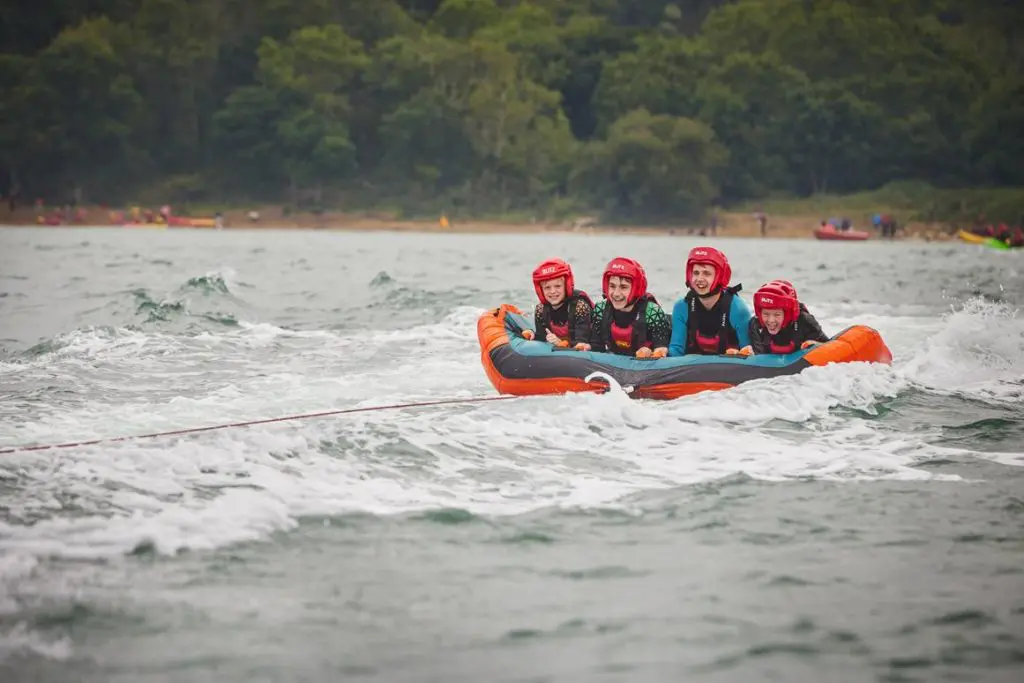school pupils in lake on a inflatable raft