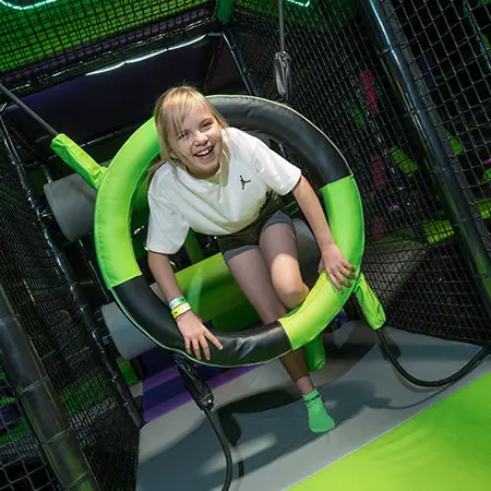 primary school child in a play pen area