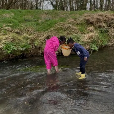 school pupils at Magdalen farm doing river experiments