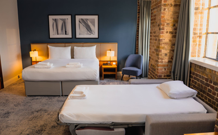 bedroom with pull out beds side tables and chairs