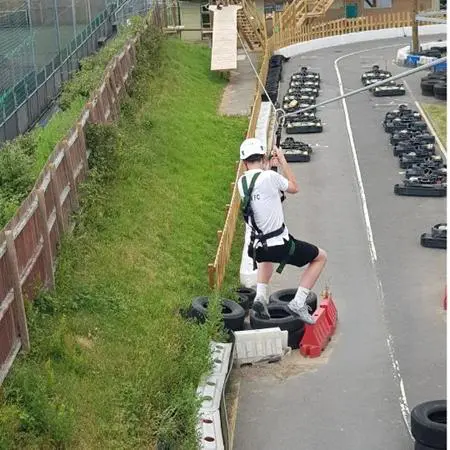 go karting track and student going down a zip line over it