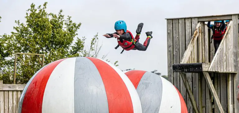 school pupil on a water assault course