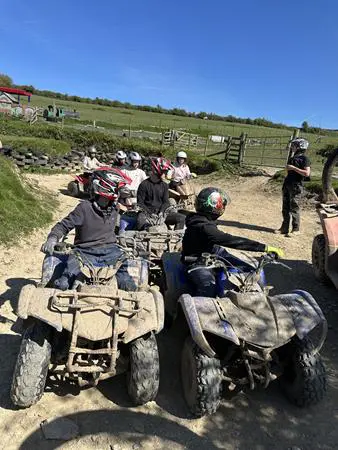 quad bikes on a track with school pupils riding them