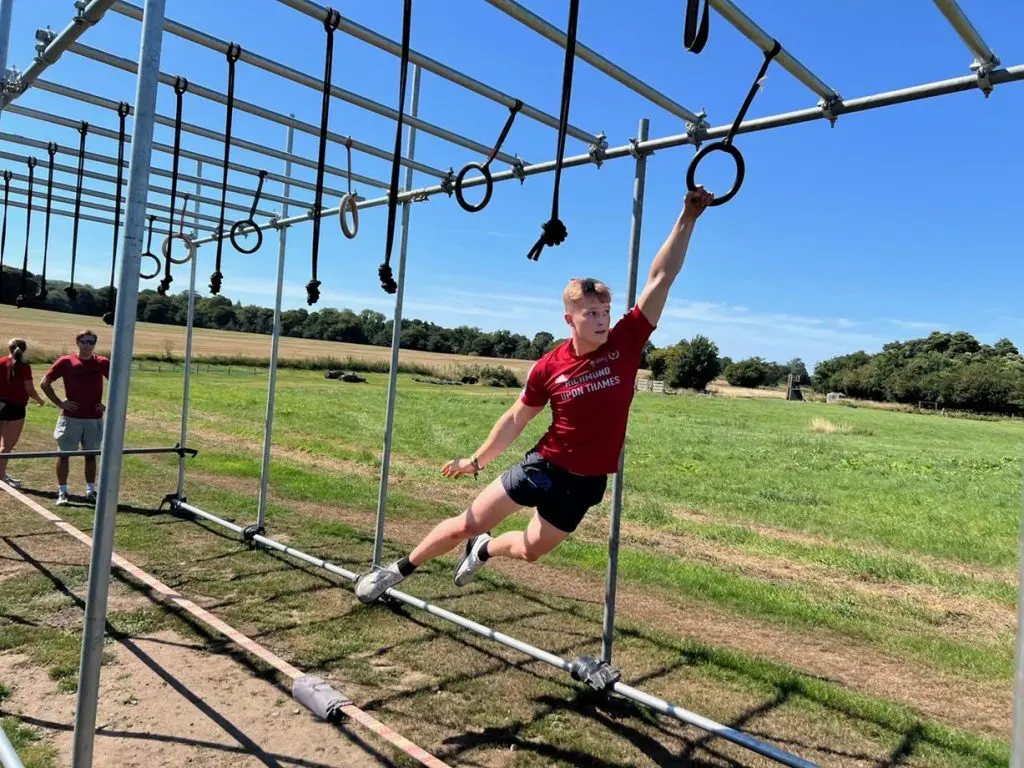 school pupil on monkey bars climbing frame
