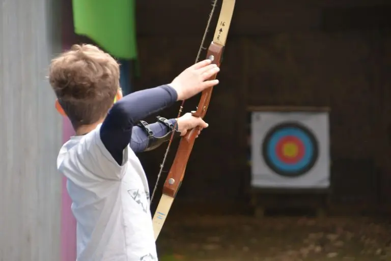 pupil on archery range at Bentley Copse activity centre