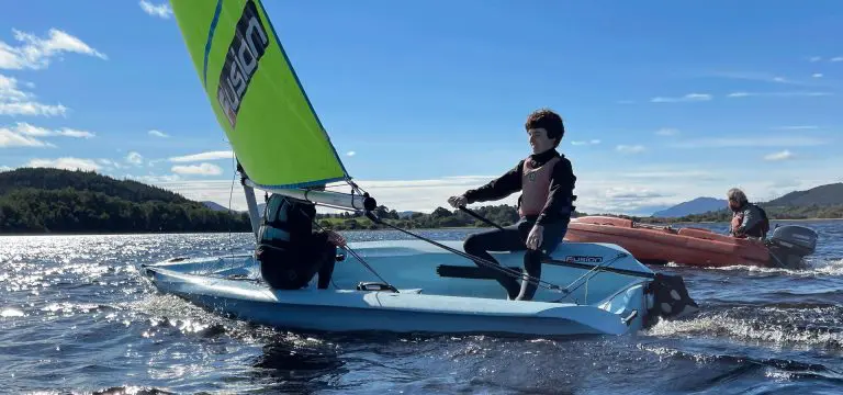 pupils on a small boat sailing on a lake at Cairngorms national park