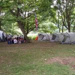 group of school students outside in a camping area
