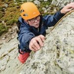 school pupil rock climbing up a cliff in Snowdonia Wales