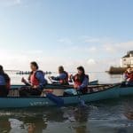 4 teams of school pupils in three person canoes on a lake in Snowdonia Wales