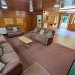 indoor social area room with sofas, tables and chairs for school groups