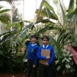 school children at the Birmingham botanical glasshouse by tropical trees
