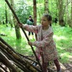 pupil making den out of wood