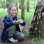 primary student by tree
