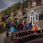 Accommodation building with a school trip group standing by entrance