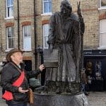 tour guide next to a statue in Canterbury city centre
