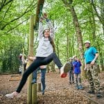 school pupil in the woods on a climbing ropes assault course