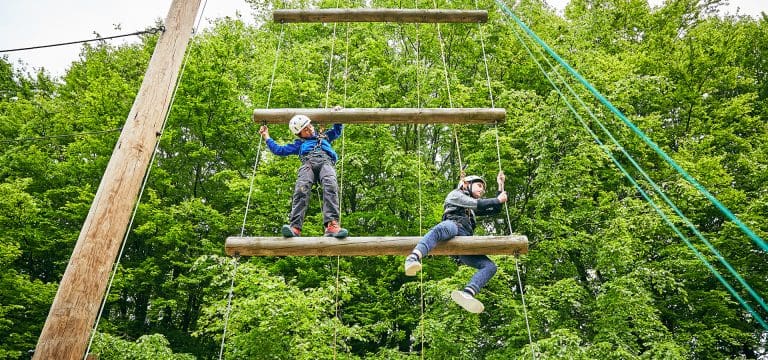 school pupils on a high ropes course at an activity adventure centre