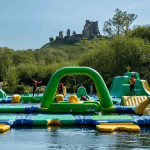 pupils having fun on a water obstacle course