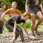 school pupils on a muddy assault course