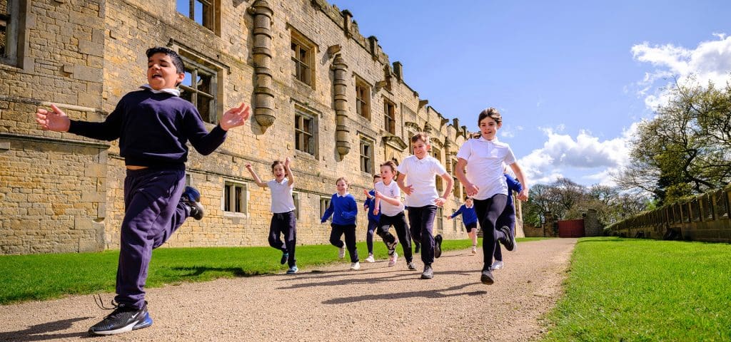 English Heritage East Midlands 7 school pupils running next to a Tudor country estate