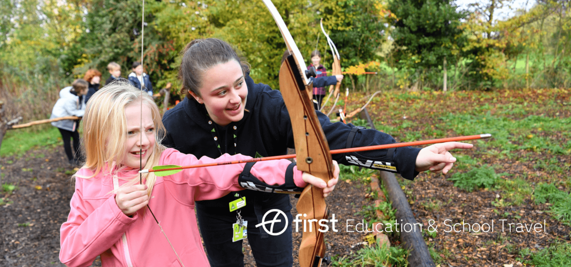 school pupil with instructor on an archery range