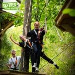 school pupils on a high ropes course high up in the tress at bluewater