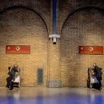 pupils standing below a sign called hogwarts express