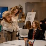 tour guide showing pupils in a study room film exhibits from Harry Potter