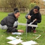 two students doing field studies outside