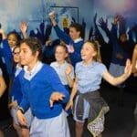 students dancing in music hall
